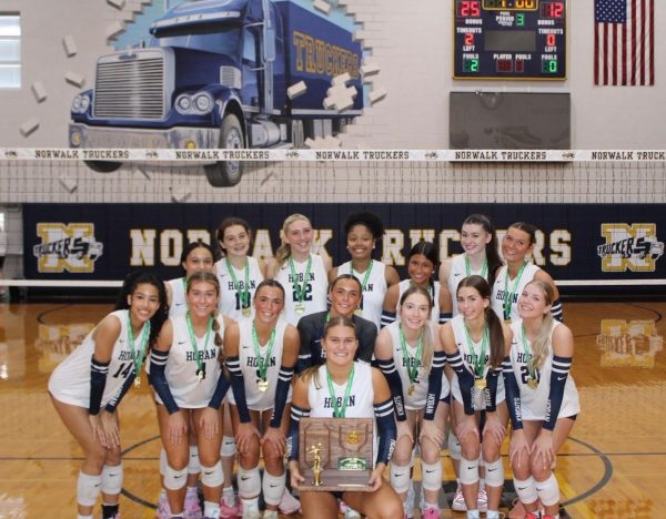 The girls volleyball team wins the regional championship against St. Ursula Academy at Norwalk High School on Nov. 1, 2025. They pose with their medals and trophy after sweeping their opponent in three sets. PHOTO COURTESY OF CHRIS  WATSON