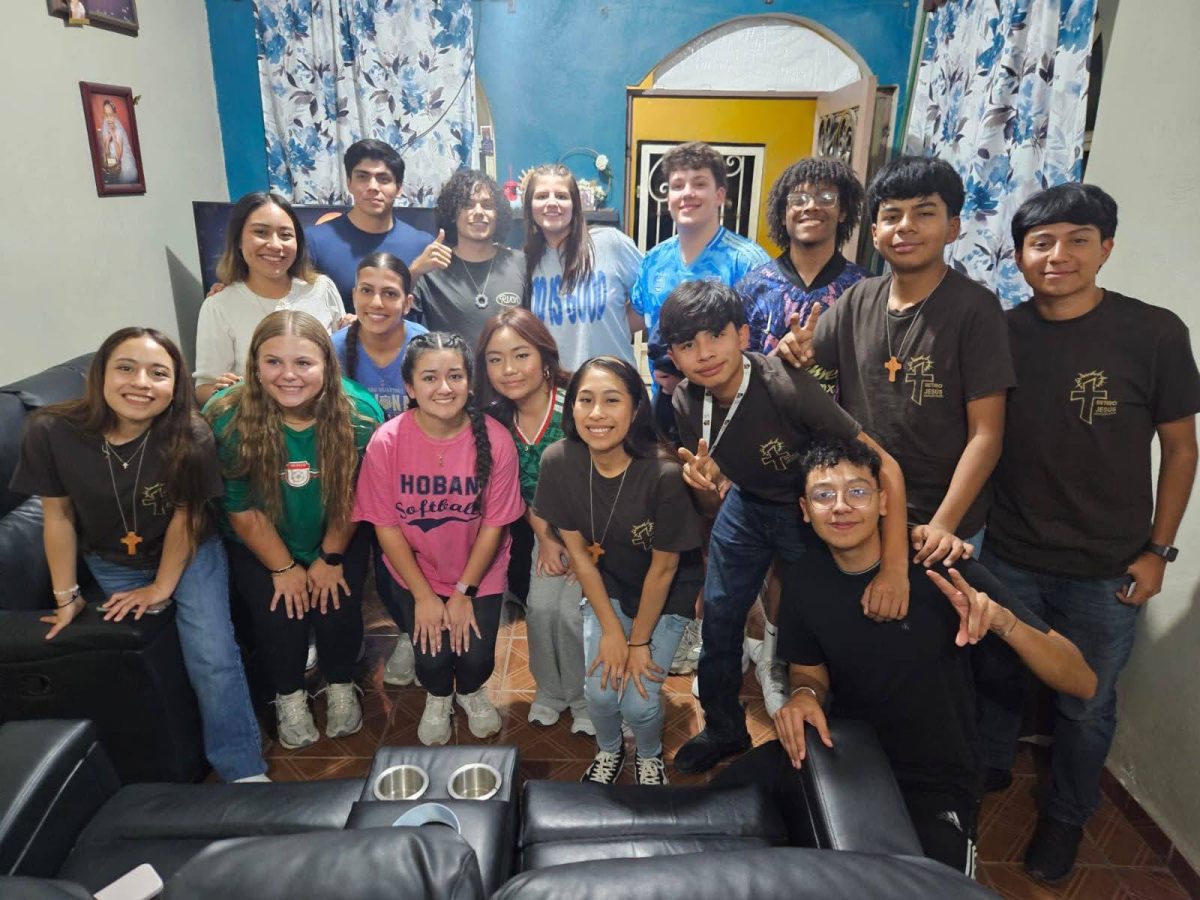 Hoban students pose with La Luz youth group. The traveling party enjoys an evening with Monterrey locals, celebrating the unity of Christian service. PHOTO COURTESY OF JESUS RODRIGUEZ
