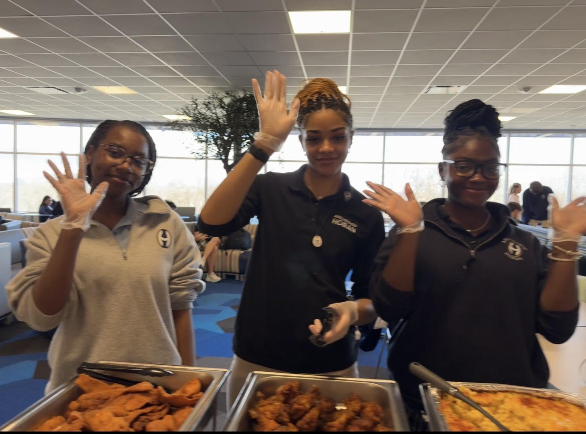 Aniyah White-Baker, Brooklyn Blair and Sa’Raya Clopton pass out soul food plates during lunch. 

PHOTO COURTESY OF SA’RAYA CLOPTON